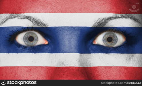 Close up of eyes. Painted face with flag of Thailand