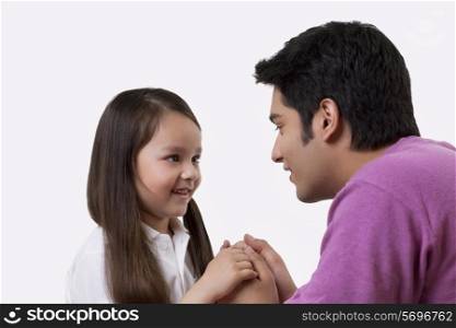 Close-up of father and daughter holding hands