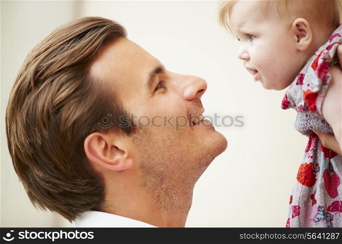 Close Up Of Father Holding Baby Daughter