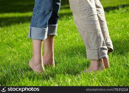 Close up of feet of a couple on a summer meadow