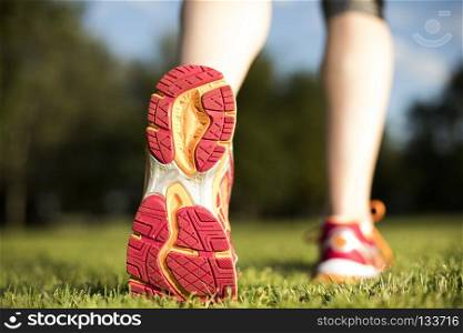 Close up of feet of a runner, training concept. Fitness woman running, Training and healthy lifestyle