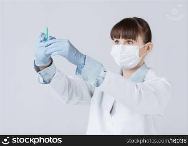 close up of female doctor holding syringe with injection