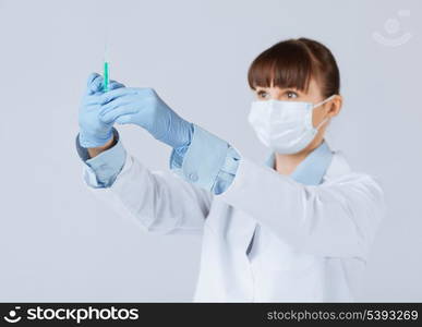 close up of female doctor holding syringe with injection