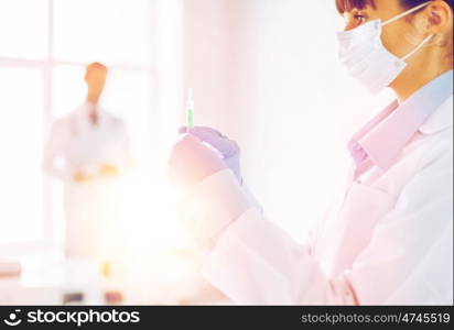 close up of female doctor holding syringe with injection. female doctor holding syringe with injection