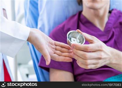 Close-up of Female doctor therapeutic advising Give Different tablets, pills, medications drugs to a man patient on bed for better healing In the room hospital background.