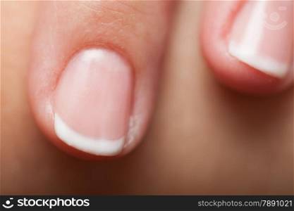 Close-up of female hand with french manicure, part of palm human fingers