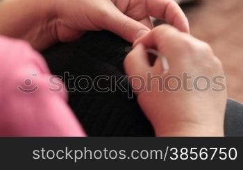 Close-up of female hands knitting.