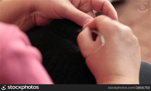 Close-up of female hands knitting.