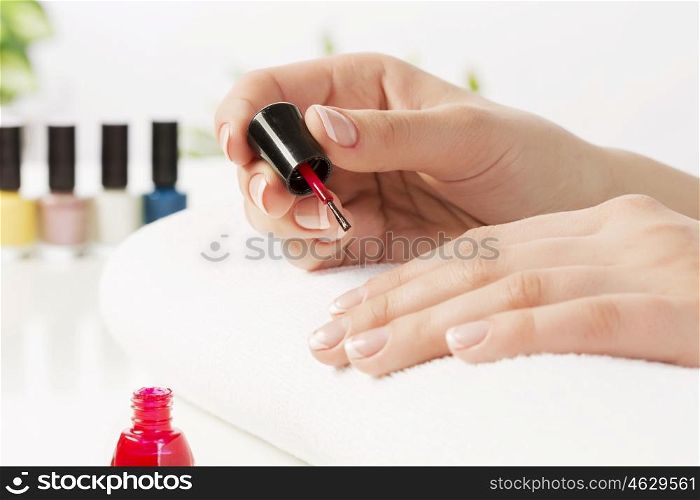 Close up of female hands making manicure