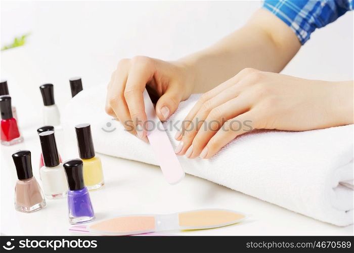 Close up of female hands making manicure