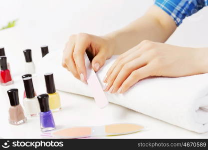 Close up of female hands making manicure