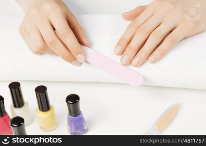 Close up of female hands making manicure