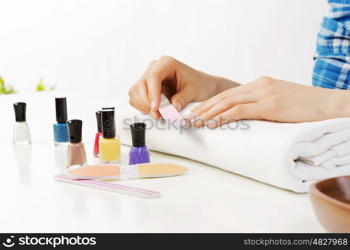 Close up of female hands making manicure