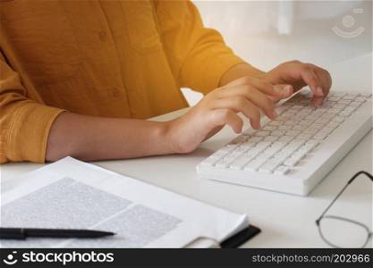 Close-up of female hands. typing in her office