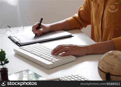 Close-up of female hands.  writing something in her office