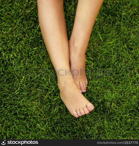 Close-up of female legs over the grass