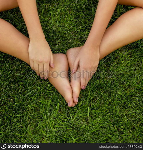 Close-up of female legs over the grass