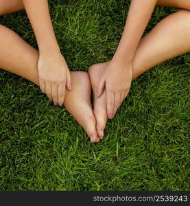 Close-up of female legs over the grass