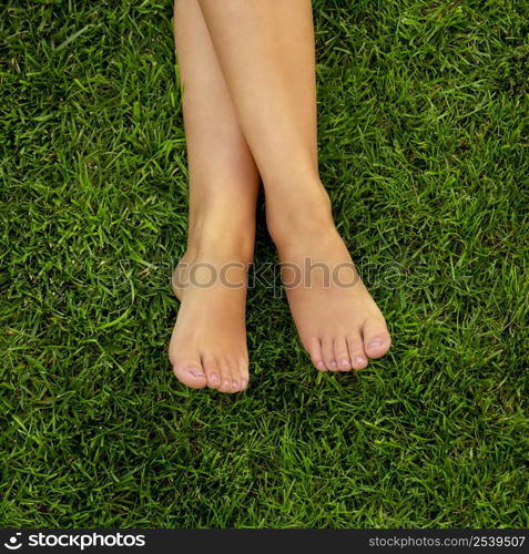 Close-up of female legs over the grass