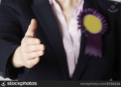 Close Up Of Female Politician Reaching Out To Shake Hands