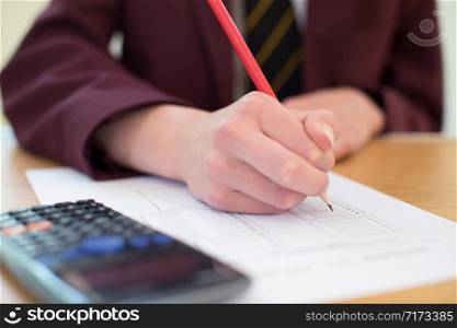 Close Up Of Female Pupil In Uniform Taking Multiple Choice Examination Paper