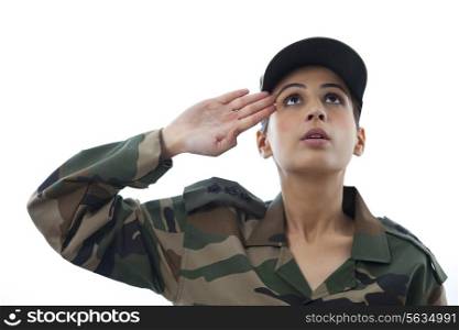 Close-up of female soldier saluting looking up