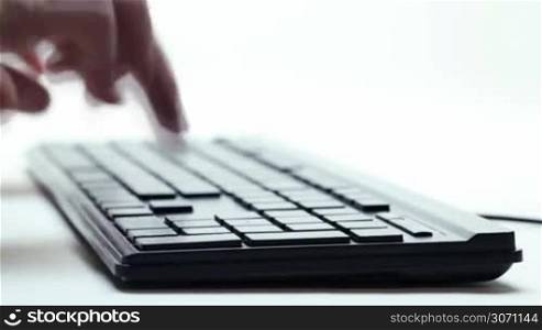 close up of fingers typing on keyboard
