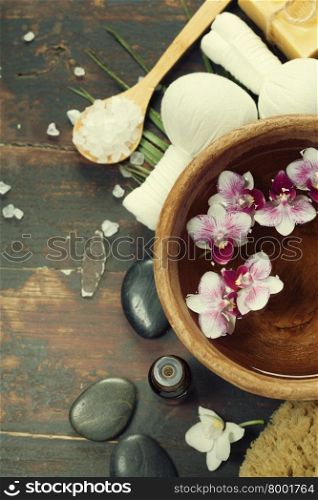 Close up of flowers floating in bowl of water and SPA setting