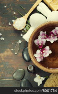 Close up of flowers floating in bowl of water and SPA setting