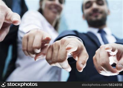 Close-up of four business people&rsquo;s fingers pointing at camera