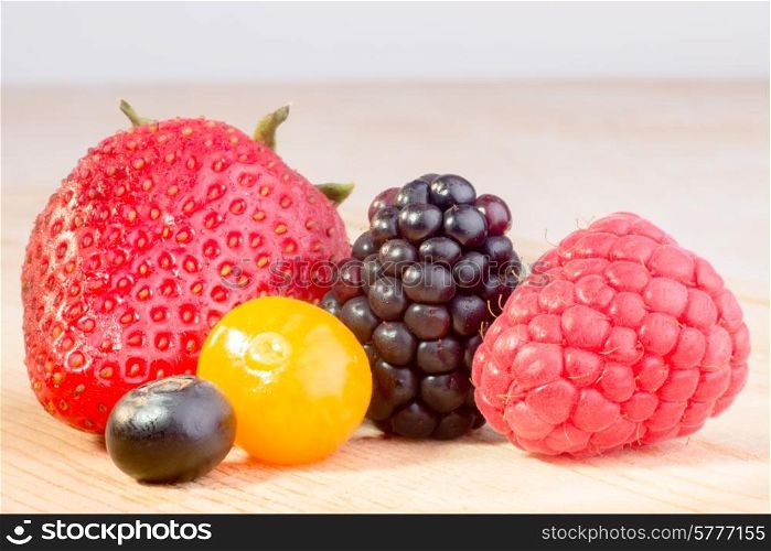 Close up of four different berries, all fresh and in Season.