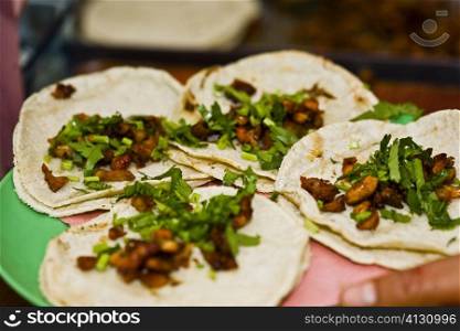 Close-up of four Mexican tacos on a plate, Cuetzalan, Puebla State, Mexico