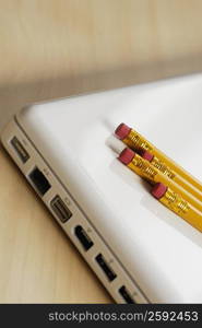 Close-up of four pencils on a laptop