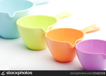 Close-up Of Four Plastic Measuring Cups