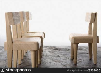 Close-up of four wooden chairs