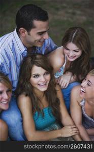 Close-up of four young women smiling with a young man