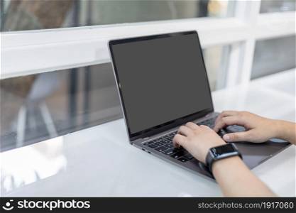 Close-up of freelance people businessfemale wearing generic design smartwatch working with laptop computer and smartphone in at the cafe,Business Lifestyle communication concept