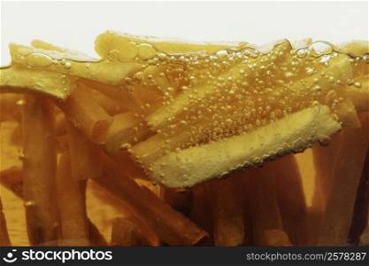 Close-up of French fries frying in oil