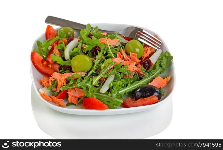 Close up of fresh green leaf salad with vegetables and smoked salmon on plate. Isolated on white background with reflection.