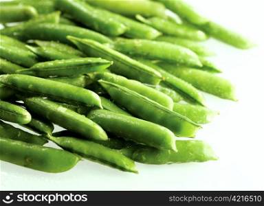 Close-up of fresh green pea pods with water drops