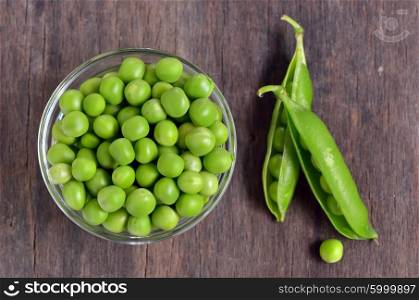 Close up of fresh peas on wooden table