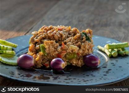 Close-up of Fresh prepared asian sweet basil minced chicken Served with Purple eggplant, Cucumber and Yard long bean. Copy space, Selective focus.
