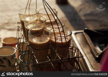 Close-up of fresh traditional Indian chai kept in grid tray