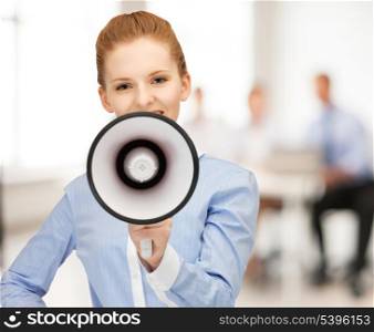 close up of friendly businesswoman with megaphone in office