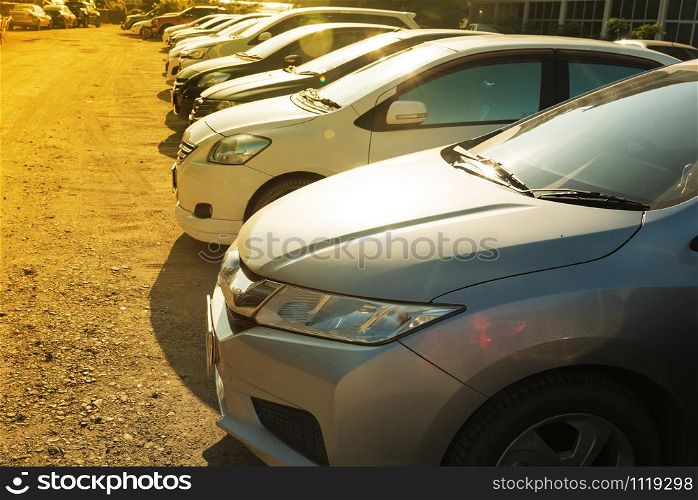Close Up of front side of cars in outdoor parking area in morning sunshine day.