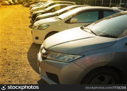 Close Up of front side of cars in outdoor parking area in morning sunshine day.