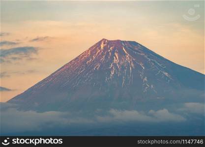 Close up of Fuji mountain peak with snow cover on the top with blue sky background, Japan