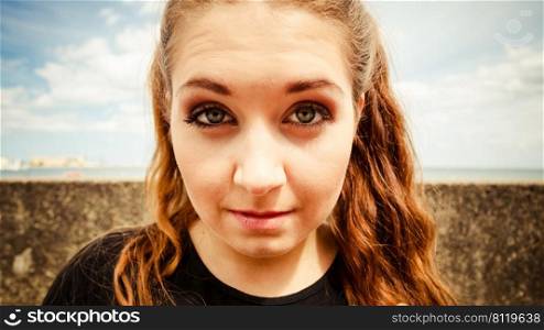 Close up of funny young teenage woman. Bizzare fish eye angle. Outdoor shot.. Close up of funny young teenage woman