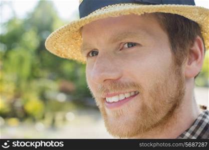Close-up of gardener smiling while looking away