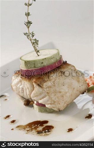 Close-up of garnished fish fillet in a plate